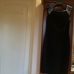 Black cocktail dress with pearls at shoulders